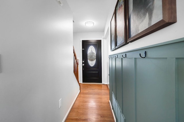 doorway to outside featuring stairs, visible vents, light wood-style floors, and baseboards