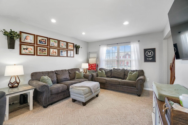 living room with recessed lighting, baseboards, and light carpet