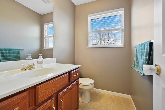 bathroom featuring visible vents, baseboards, toilet, tile patterned floors, and vanity