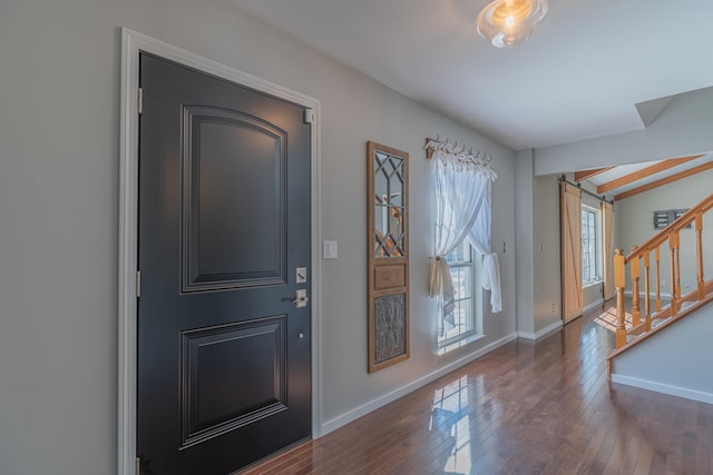 entryway featuring stairs, baseboards, and hardwood / wood-style flooring