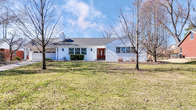 single story home with a front lawn, an attached garage, driveway, and a chimney