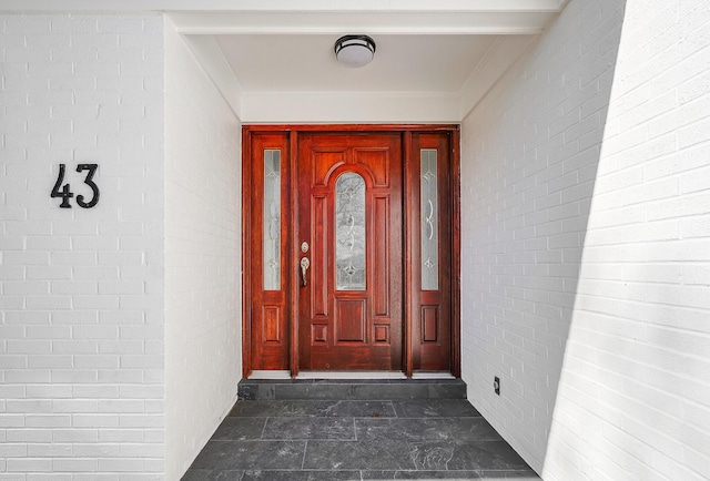 property entrance with brick siding