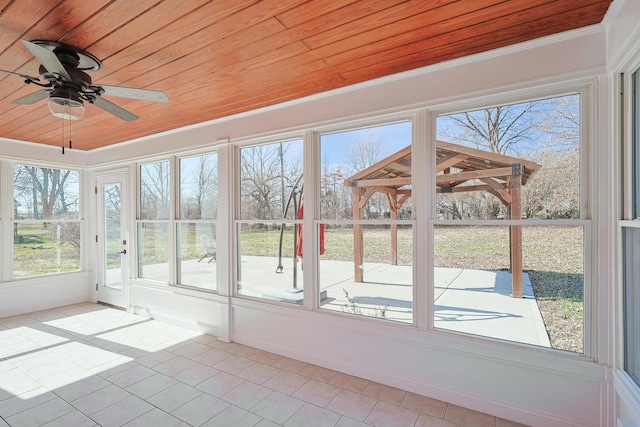 unfurnished sunroom featuring wood ceiling and ceiling fan