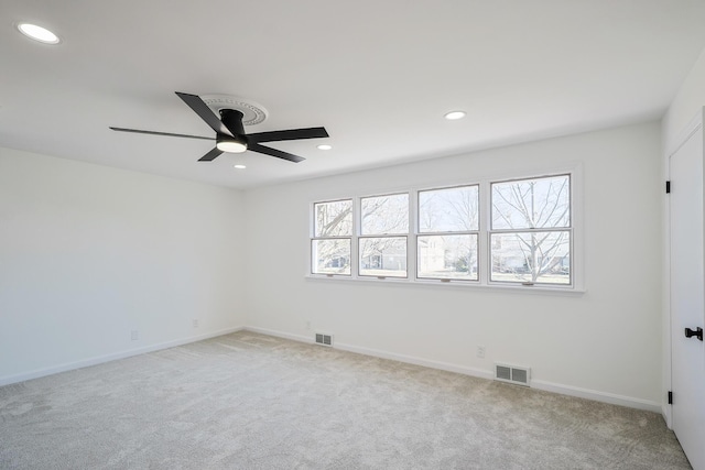 unfurnished room with recessed lighting, visible vents, and light colored carpet