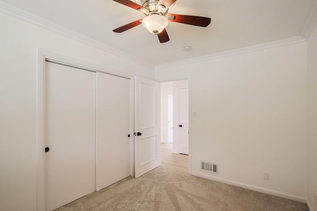 unfurnished bedroom featuring crown molding, visible vents, and light carpet