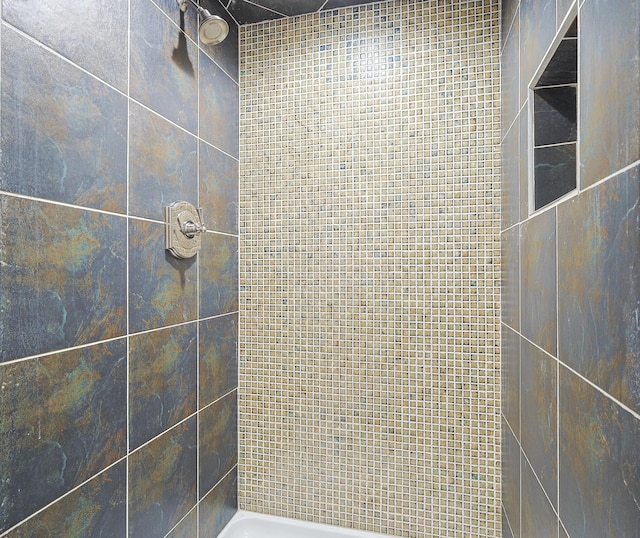 bathroom with a tile shower