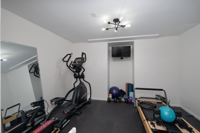 workout area featuring baseboards