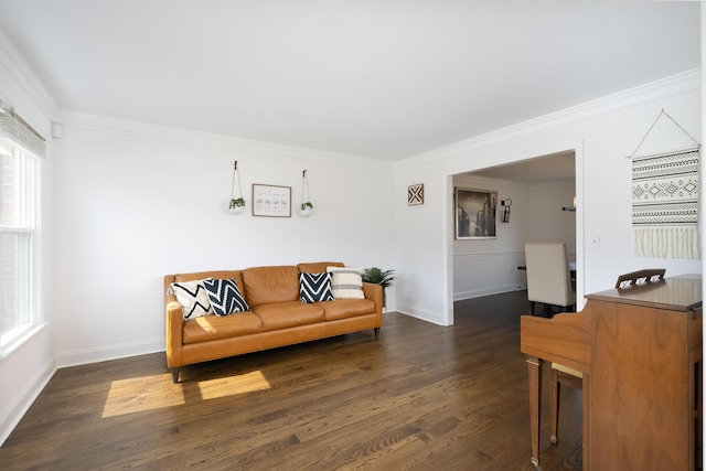 living room featuring dark wood-style floors, baseboards, and ornamental molding