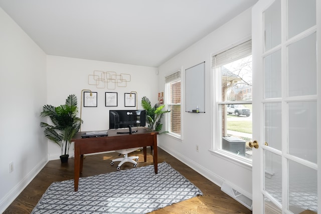 office area with a wealth of natural light, baseboards, and wood finished floors