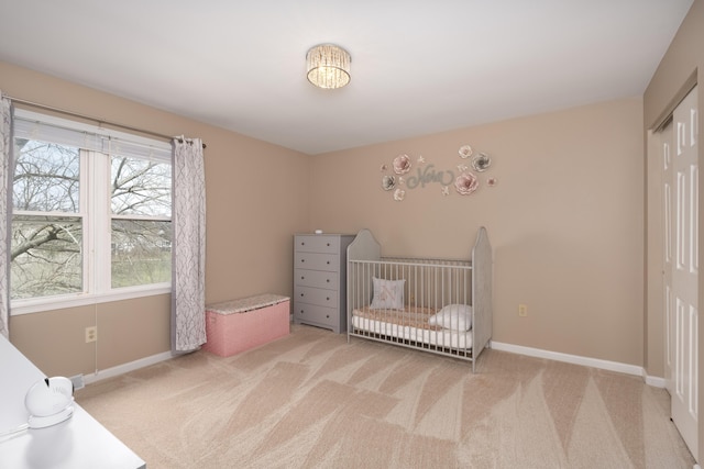 unfurnished bedroom featuring a closet, baseboards, and light colored carpet