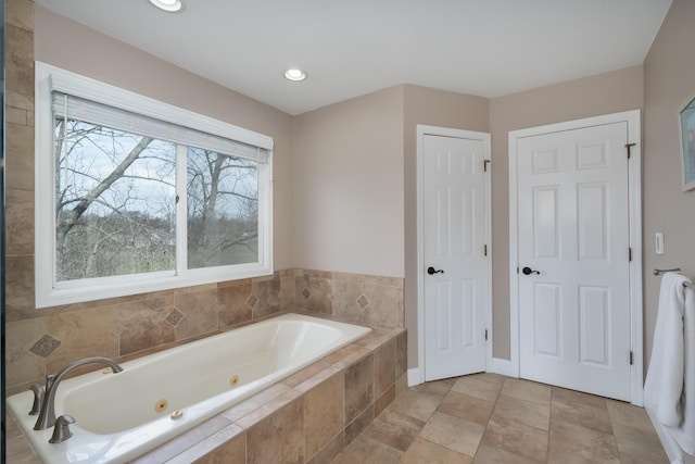 bathroom featuring a tub with jets and recessed lighting