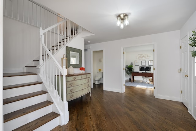 stairs with baseboards and wood finished floors