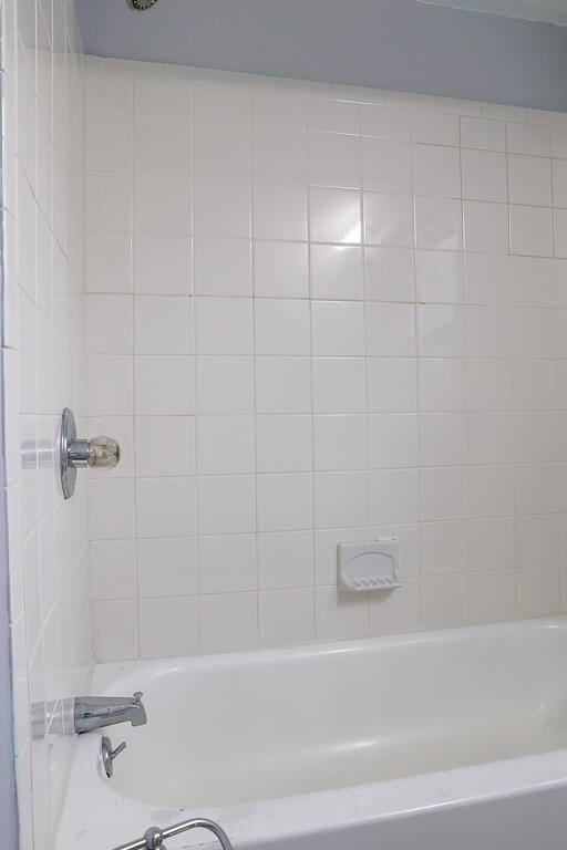 bathroom with bathing tub / shower combination