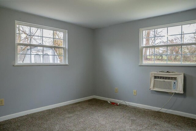unfurnished room with plenty of natural light, baseboards, and carpet floors