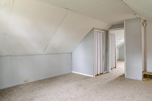 bonus room with lofted ceiling and carpet floors