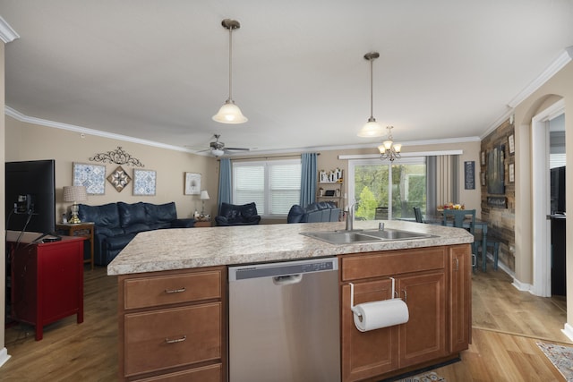 kitchen with stainless steel dishwasher, light countertops, light wood-type flooring, and a sink