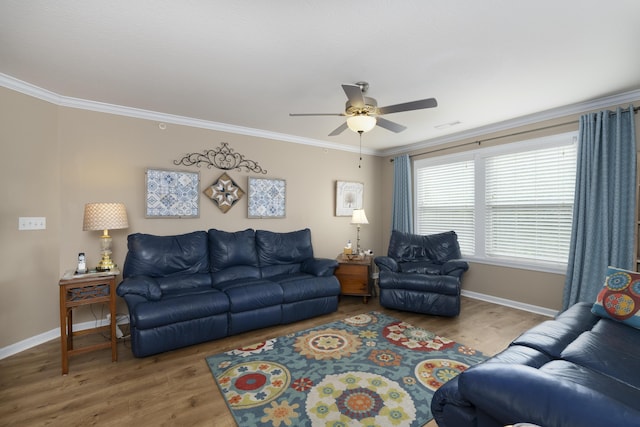 living area with ceiling fan, wood finished floors, baseboards, and ornamental molding