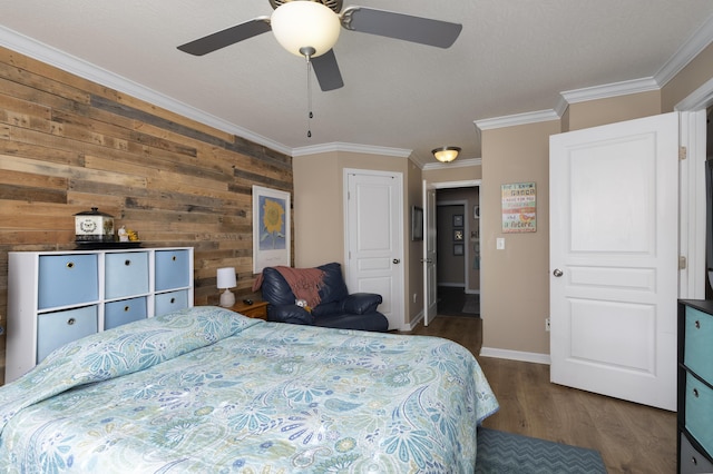 bedroom with ornamental molding, a ceiling fan, baseboards, and wood finished floors