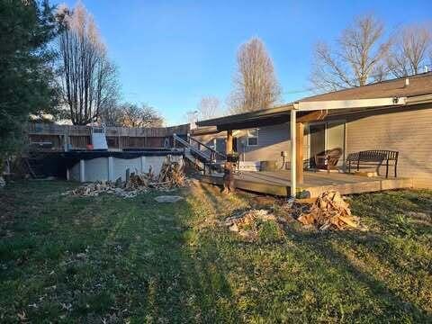 125 Smith Ave, Warsaw, KY 41095 - rear view of property featuring a covered pool, a lawn, and a wooden deck