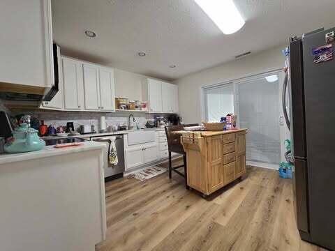 125 Smith Ave, Warsaw, KY 41095 - kitchen featuring a sink, appliances with stainless steel finishes, light wood-style flooring, and white cabinetry