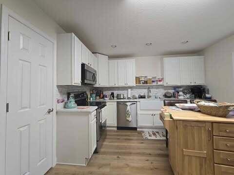125 Smith Ave, Warsaw, KY 41095 - kitchen with a sink, stainless steel appliances, light countertops, and white cabinetry