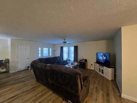 125 Smith Ave, Warsaw, KY 41095 - living area with ceiling fan, baseboards, a textured ceiling, and light wood-style flooring