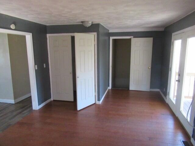 interior space featuring wood finished floors and baseboards