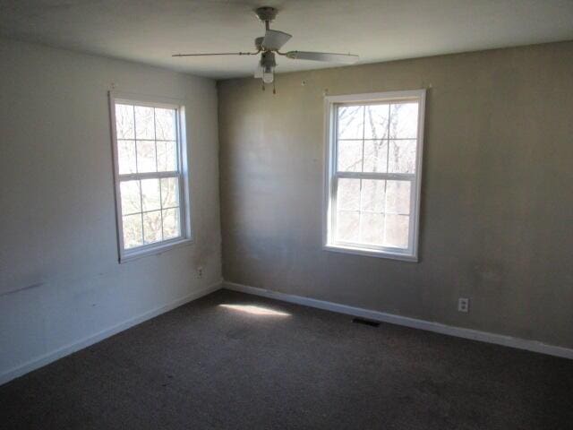unfurnished room with visible vents, ceiling fan, baseboards, and carpet floors