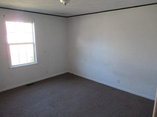 carpeted empty room with visible vents and baseboards