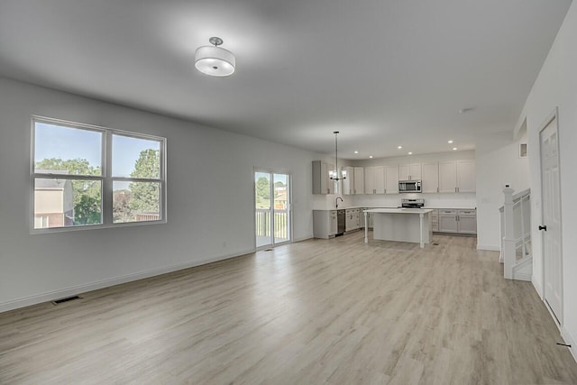 350 Foxhunt Dr, Walton, KY 41094 - unfurnished living room with light wood-type flooring, recessed lighting, baseboards, and a chandelier