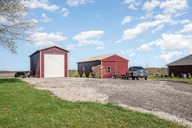 view of outbuilding with an outdoor structure, gravel driveway, and central AC