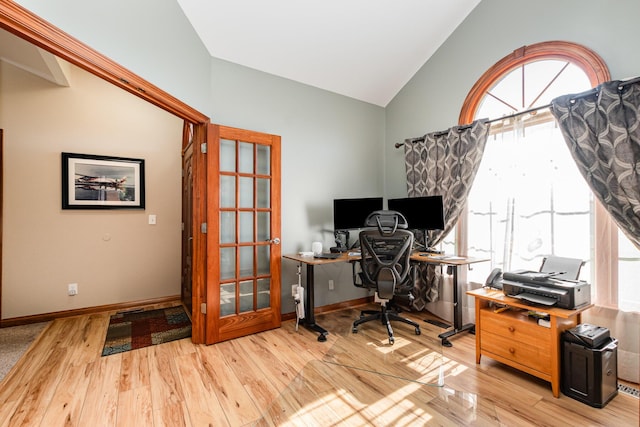 office space featuring baseboards, vaulted ceiling, wood finished floors, and french doors
