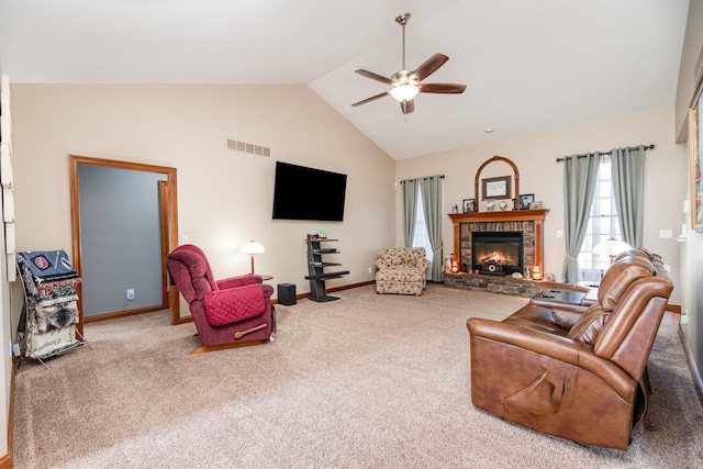 living room with carpet flooring, ceiling fan, visible vents, and a stone fireplace