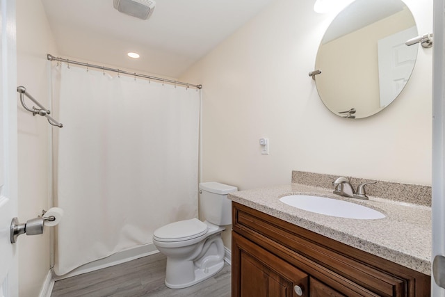 bathroom featuring toilet, a shower with curtain, vanity, and wood finished floors