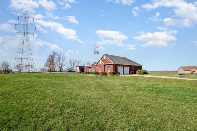 view of yard with driveway and a garage