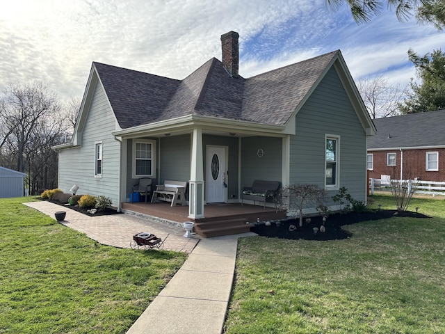 98 S Main St, Dry Ridge, KY 41035 - bungalow-style home with a chimney, a shingled roof, fence, and a front lawn