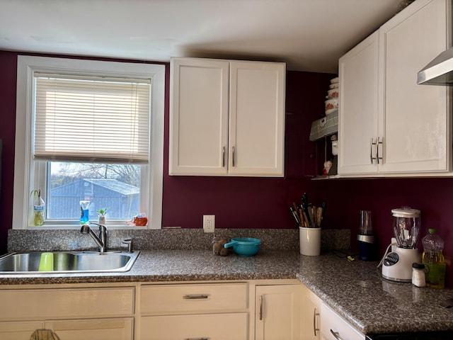 98 S Main St, Dry Ridge, KY 41035 - kitchen with wall chimney range hood, white cabinets, and a sink
