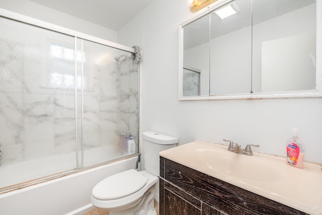 bathroom featuring toilet, vanity, and enclosed tub / shower combo