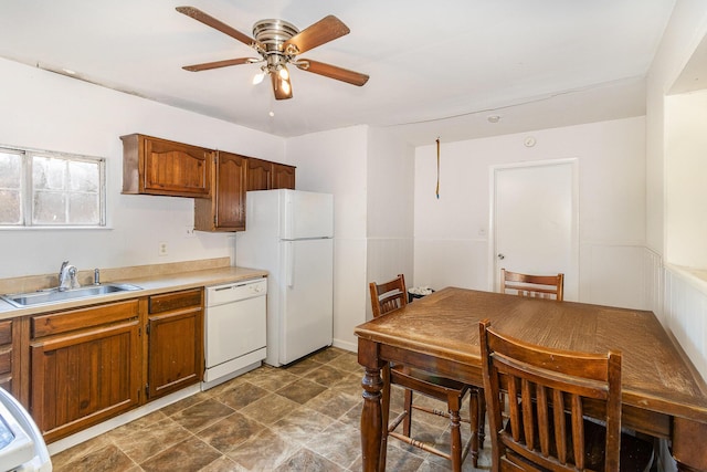 kitchen with white appliances, light countertops, a sink, and a ceiling fan