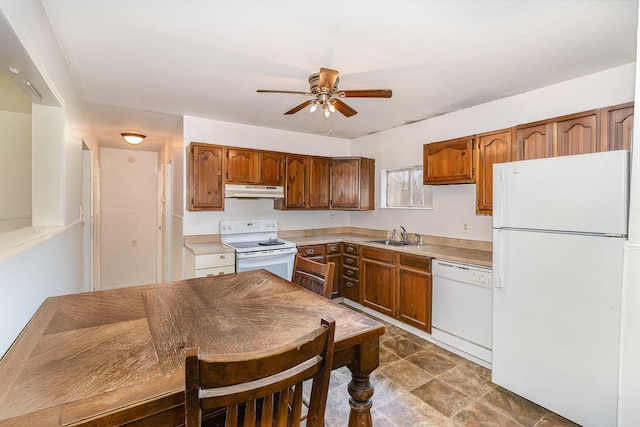 kitchen featuring light countertops, a sink, a ceiling fan, and white appliances