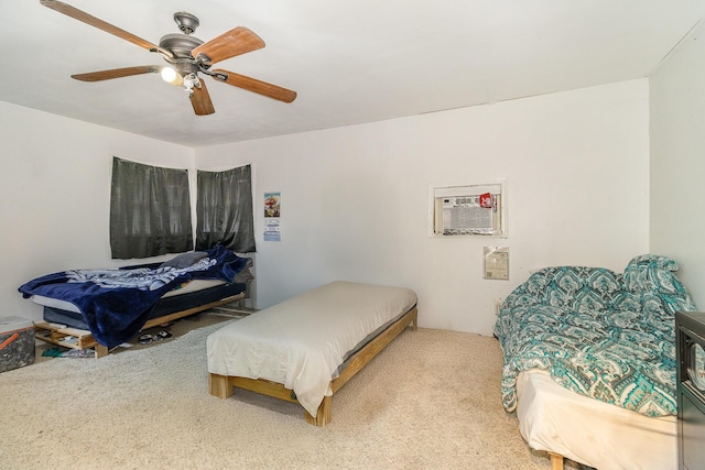 bedroom with a wall mounted air conditioner, a ceiling fan, and carpet