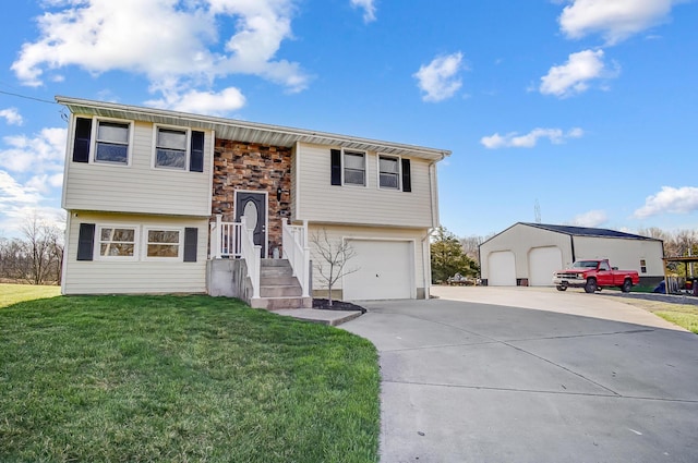 raised ranch featuring a front yard, driveway, an attached garage, and stone siding