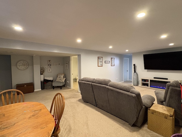 living area featuring light carpet and recessed lighting