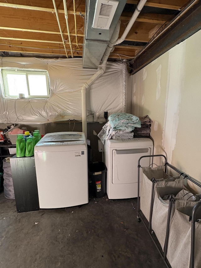 washroom with independent washer and dryer and laundry area