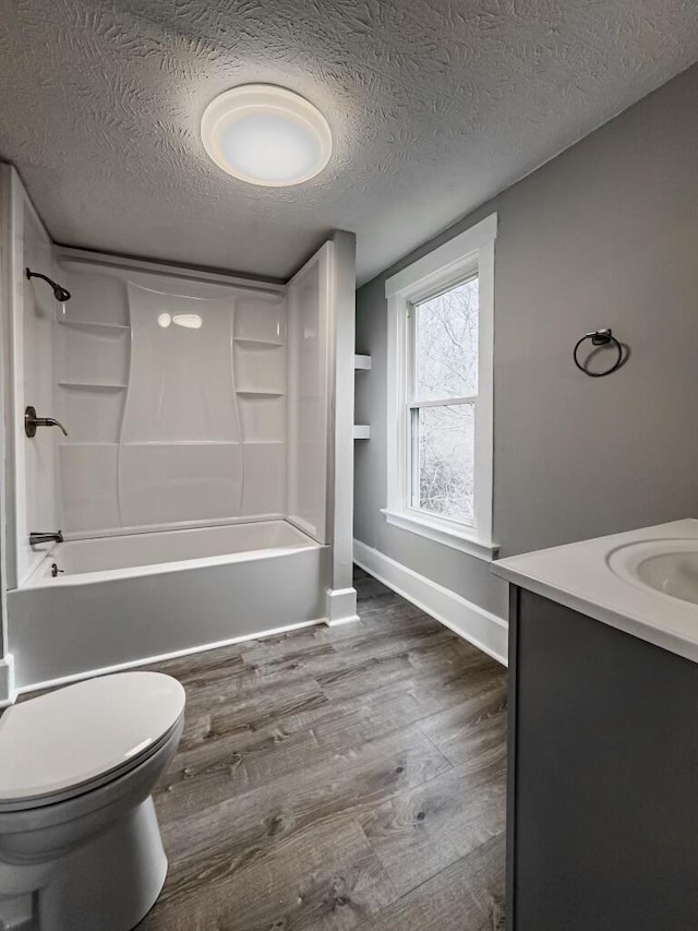 2750 Madison Ave, Covington, KY 41015 - full bathroom featuring toilet,  shower combination, wood finished floors, and a textured ceiling