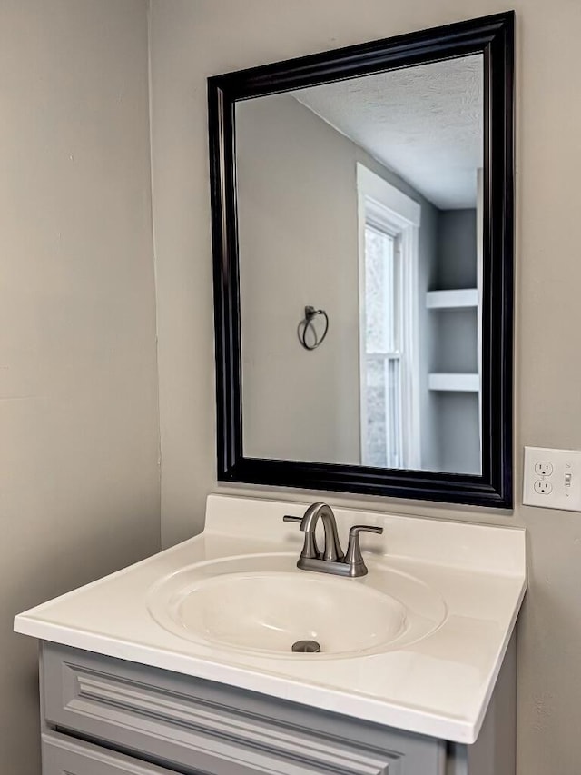 2750 Madison Ave, Covington, KY 41015 - bathroom featuring a textured ceiling and vanity