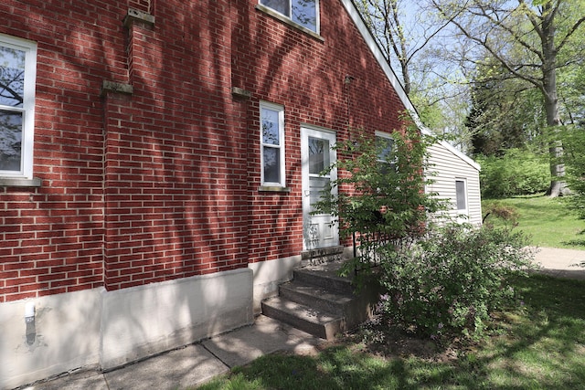 view of property exterior featuring brick siding