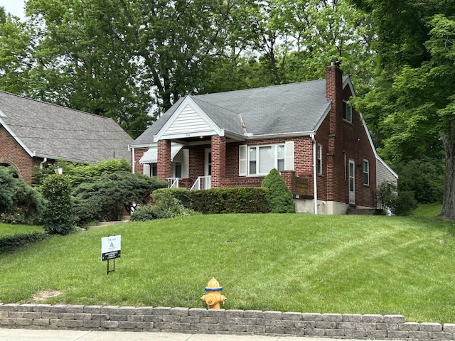 64 Edgewood Rd, Edgewood, KY 41017 - view of front of property featuring brick siding, a front lawn, a chimney, roof with shingles, and a porch