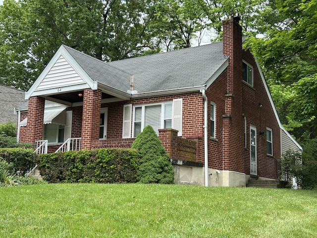 64 Edgewood Rd, Edgewood, KY 41017 - view of front of property with a front yard, brick siding, a chimney, a shingled roof, and covered porch