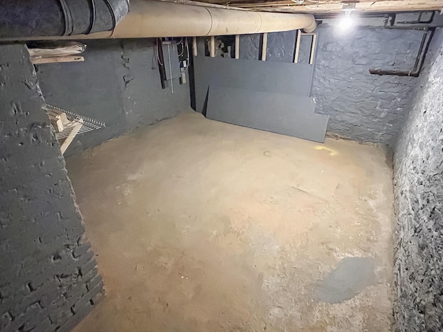 unfinished below grade area with electric panel